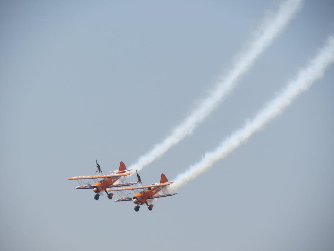 red and white jet plane in mid air during daytime