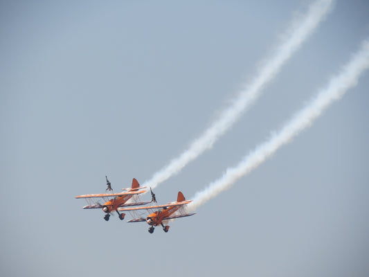 red and white jet plane in mid air during daytime