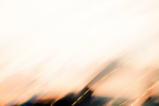 a blurry photo of a building with a sky in the background