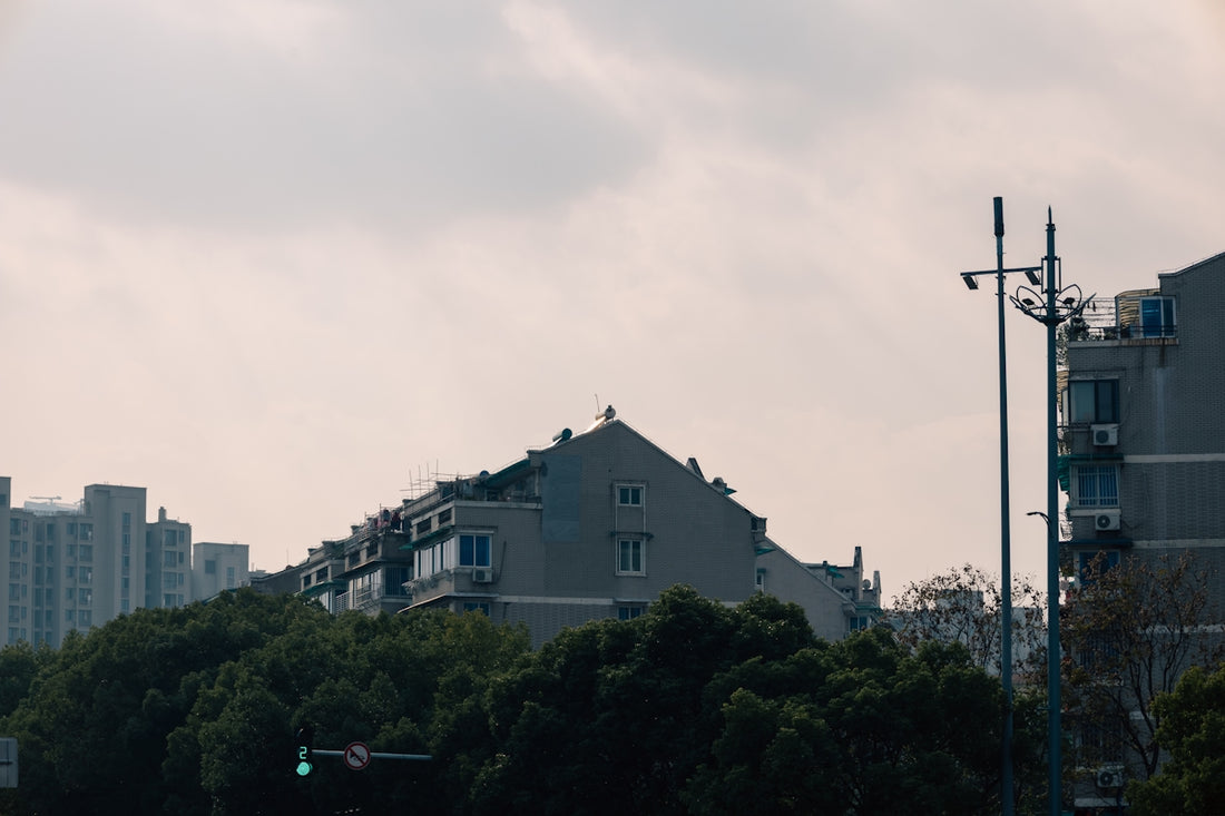 a green traffic light sitting next to a tall building
