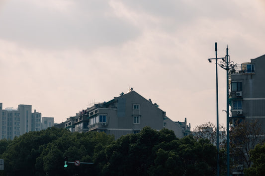 a green traffic light sitting next to a tall building