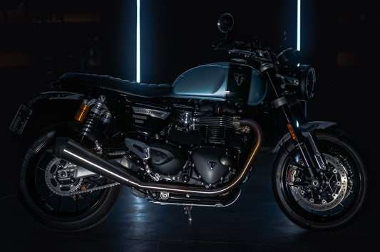 A black motorcycle parked in a dark room
