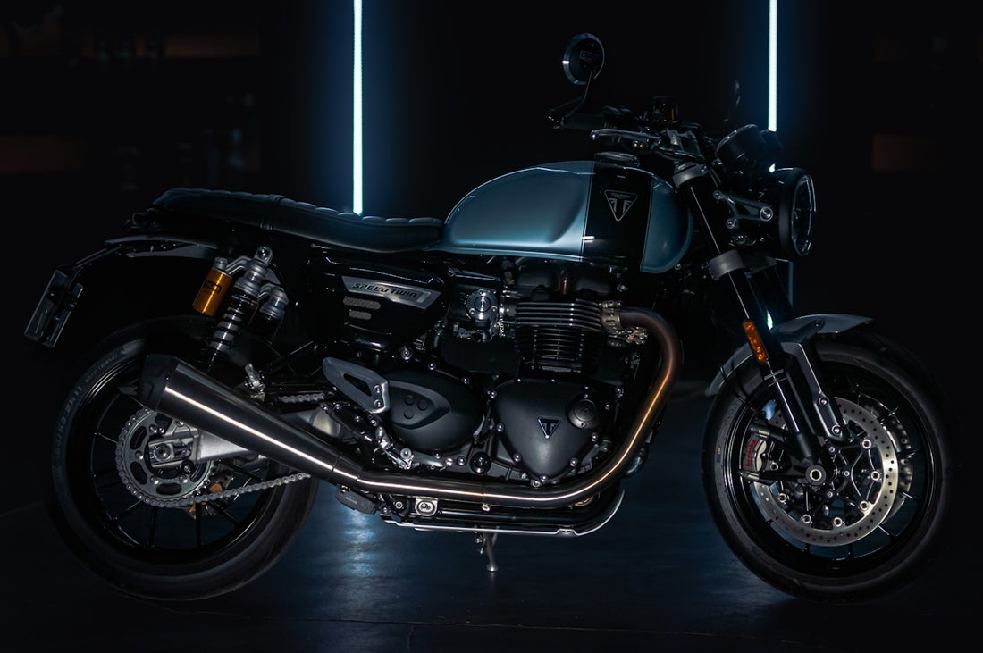 A black motorcycle parked in a dark room