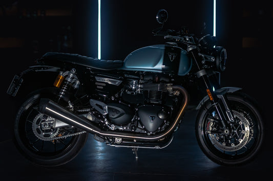A black motorcycle parked in a dark room