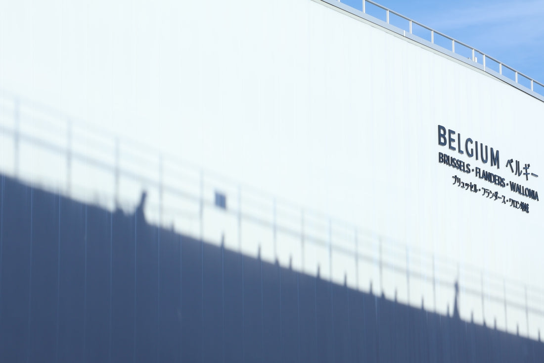 Modern white building with shadows and text.