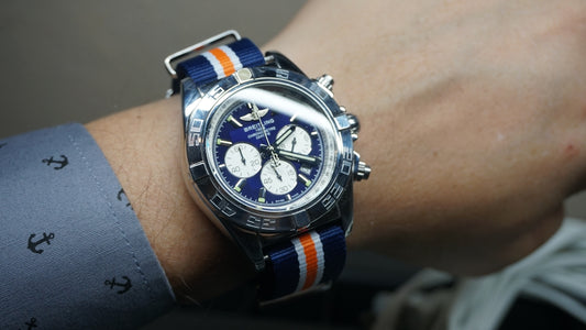 Man wearing a blue faced chronograph watch