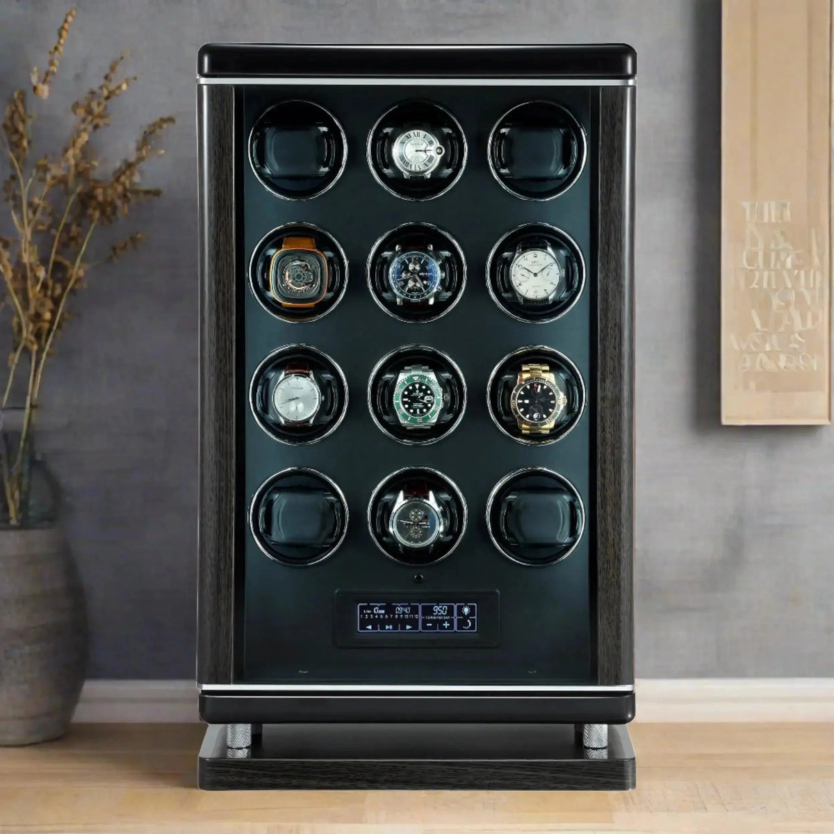 The Tempus Luxury Watch Winders 12 Watch Winder for Automatic Watches for men with BioMetric Technology stands on a wood surface, displaying twelve watches in individual compartments and a digital control panel, beside a vase with dried plants.